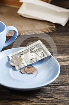 Restaurant tips in american banknotes and coins