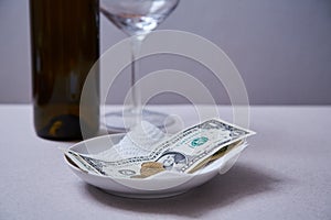 Restaurant tips or gratuity. Banknotes and coins on a plate photo