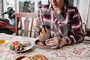 A restaurant visitor eats a national Turkish dish in a pot that is broken before being consumed called Testi-kebab