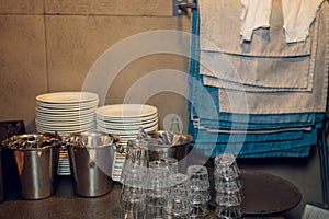 Restaurant waiter serves a table, close-up. The waiter serves empty tableware, table setting. The waitress puts the fork