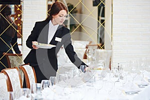 Restaurant waitress serving table with food