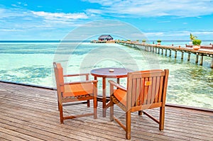 Restaurant on a wooden pier against the azure water of the ocean