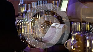 Restaurant worker typing on cash register, accepting order from customer