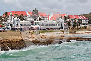 Restaurants and pubs at the Beachfront Boardwalk in Summerstrand Port Elizabeth with people taking a morning stroll  - Photo taken