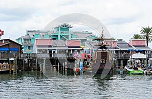 The restaurants and ship on the dock by John`s Pass and the canal near Madeira Beach, Florida, U.S