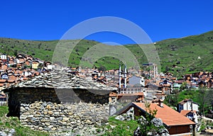View to old Dervish turbe and new mosques with two minarets in Restelica village. photo