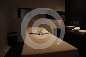 Restful bed in massage room of a spa