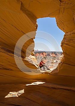 Resting in the Alcove overlooking the teepee formations of sandstone cones of Northe Coyote Buttes in northern Arizona on the