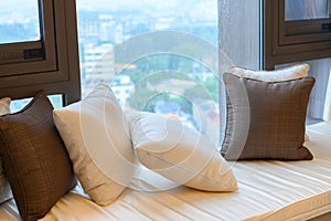 Resting area of cozy window seat with cushion in the morning horizontal composition