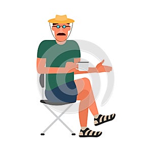 Resting man sitting on a folding chair in a T-shirt, shorts, and a hat.