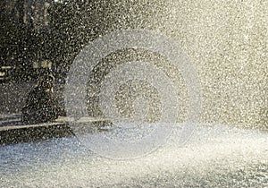 Resting people behind water drops curtain, Fountain in the Liberty Square Plac Wolnosci Poznan, Poland. photo