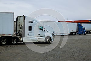 Resting place the truck stop on various types of trucks in a parking lot off the highway with gas station for refueling