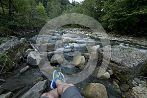 Resting on rocks near a river