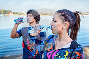 Resting After Workout-Woman drinks water to replenish energy