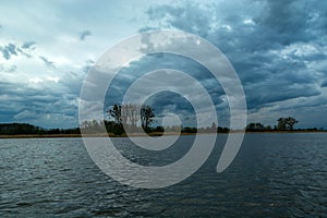 Restless evening clouds over a calm lake