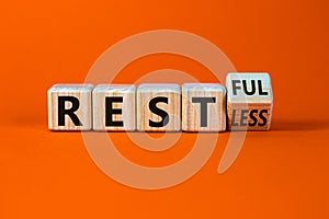 Restless or restful symbol. Turned the wooden cube, changed the word `restless` to `restful`. Beautiful orange table, orange