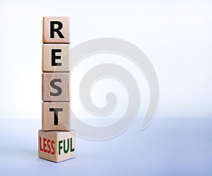 Restless or restful symbol. Turned the wooden cube, changed the word `restless` to `restful`. Beautiful white table, white
