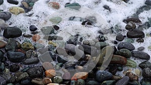 restless waves thrash against the pebble shoreline,