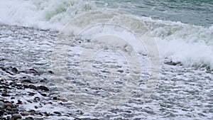 restless waves thrash against the pebble shoreline,