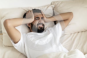 Restless Young Indian Man Waking Up In The Morning With Headache