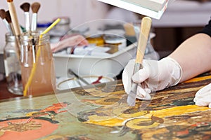 Restoration of Christian icon with agate burnisher