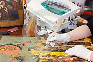 Restoration of Christian icon with agate burnisher photo