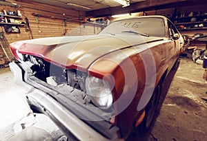 Restoration of classic car. Close up view front side classic car, front headlight of a broken dusty car during road