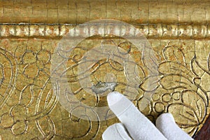 Restoration: gold restoration, old icon. close up. conservation of paintings. conservation of sculptures