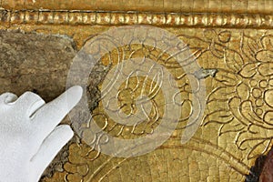 Restoration: gold restoration, old icon. close up. conservation of paintings. conservation of sculptures