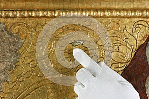 Restoration: gold restoration, old icon. close up. conservation of paintings. conservation of sculptures