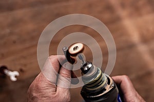 Restoration of an old Nagan revolver bullet case with a grinding machine. War finds of the early 20th century