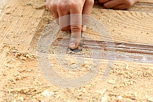 Restoration of wooden doors,a working carpenter peels off paint from a wooden product with a spatula.furniture restoration concept