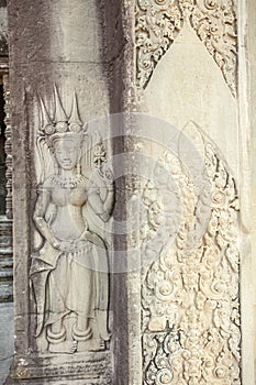Restored Apsara relief at the entrance of Ta Prohm temple, Angkor Thom, Siem Reap, Cambodia.