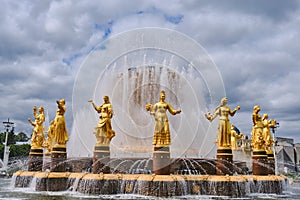 The restored Fountain Friendship of Peoples at VDNH, beautiful golden statues. Moscow, Russia 05 24 2019