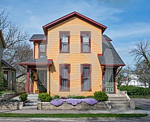 Restored Orange Duplex House with Purple Phlox photo