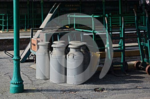 Railway milk churns on station platform.