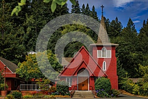 Red facade of Saint Philip the Apostle Catholic Church in Occidental, California photo