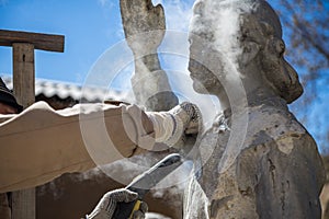 Restorer is engaged in the restoration of the statue