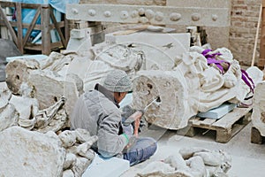 restorer fixes marble statue