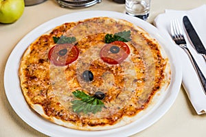 Restourant serving dish for child`s menu pizza with face