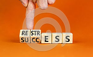 Restress for success symbol. Concept words Restress and Success on wooden cubes. Businessman hand. Beautiful orange table orange