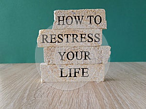 Restress your life symbol. Concept words How to restress your life on brick blocks.