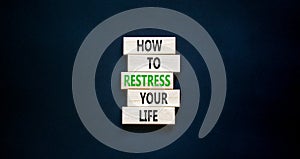 Restress your life symbol. Concept words How to restress your life on wooden blocks. Beautiful black table black background. Copy