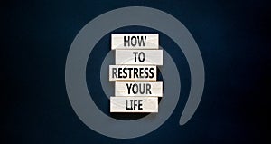 Restress your life symbol. Concept words How to restress your life on wooden blocks. Beautiful black table black background. Copy