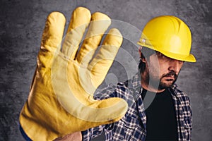 Restricted access, construction worker gesturing stop sign