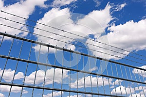 Restricted Area Concept. Metal Fence with Barbed Wire. 3d Rendering