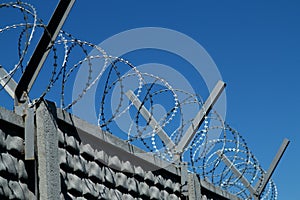 Restricted area. Passage is prohibited closed. Border from old barbed metal barrier wire. Concept of border, prison, war, military