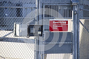 Restricted Area Sign in gated industrial power plant.