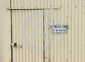 Restricted Entry and No Smoking Signs