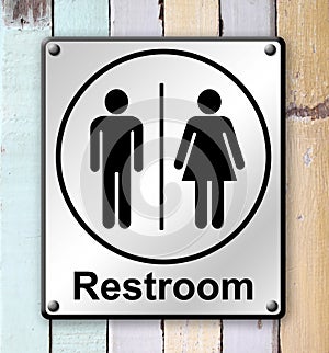 Restroom sign on old colour wooden wall